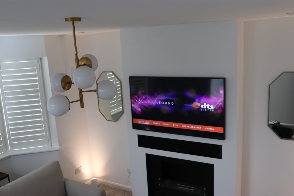 Display above fireplace-style unit with soundbar, Surrey meeting room AV set-up